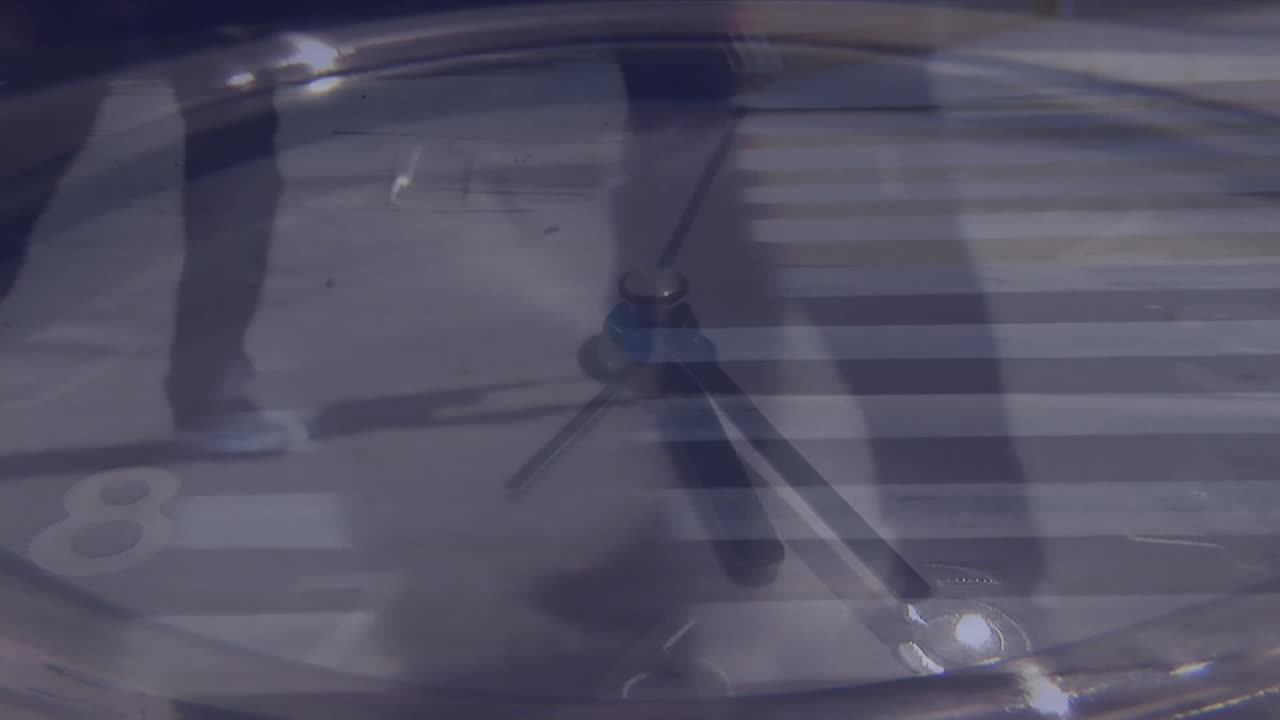 Animation of clock ticking over city background