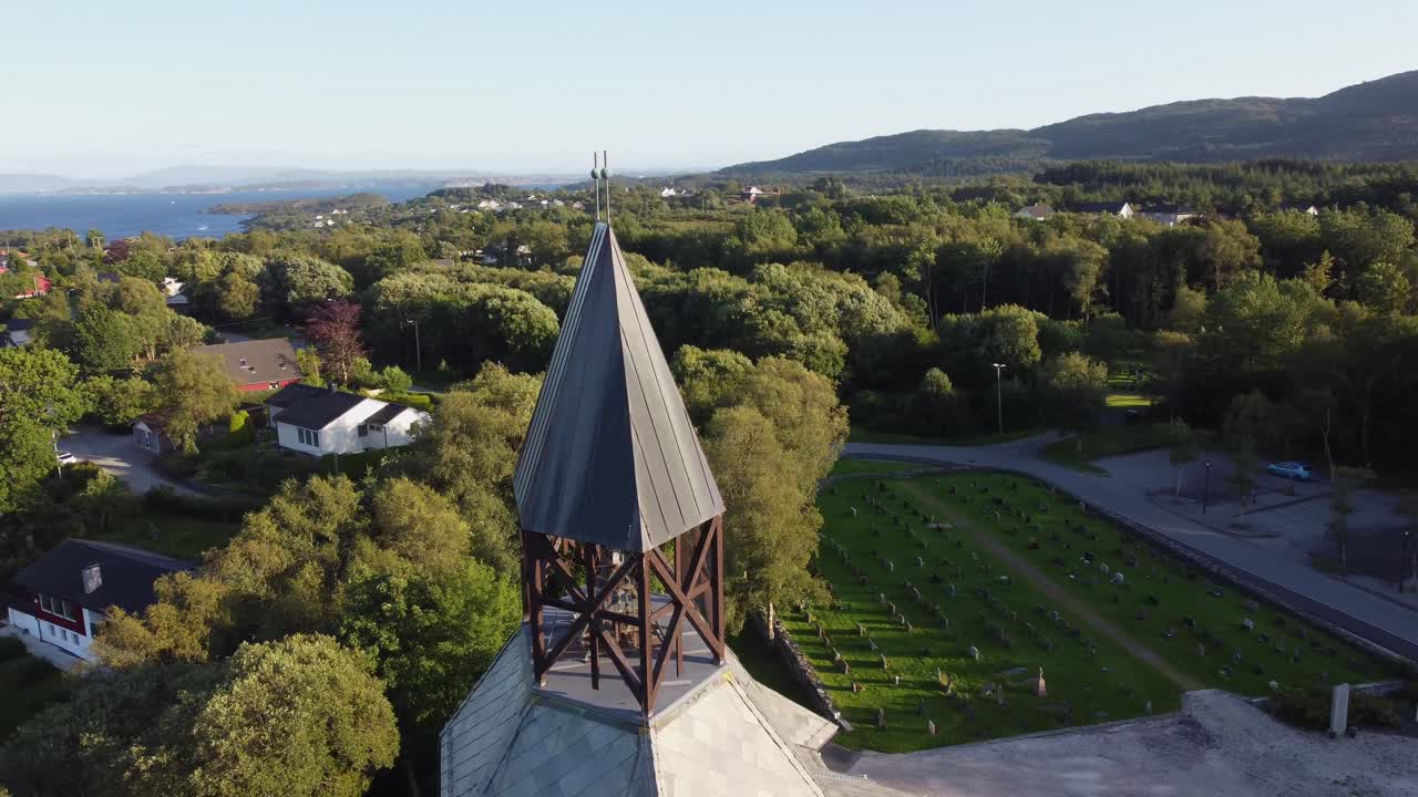 Orbiting around tower of Sund church at Sotra Norway - Afternoon with loads of solar flares and nature background