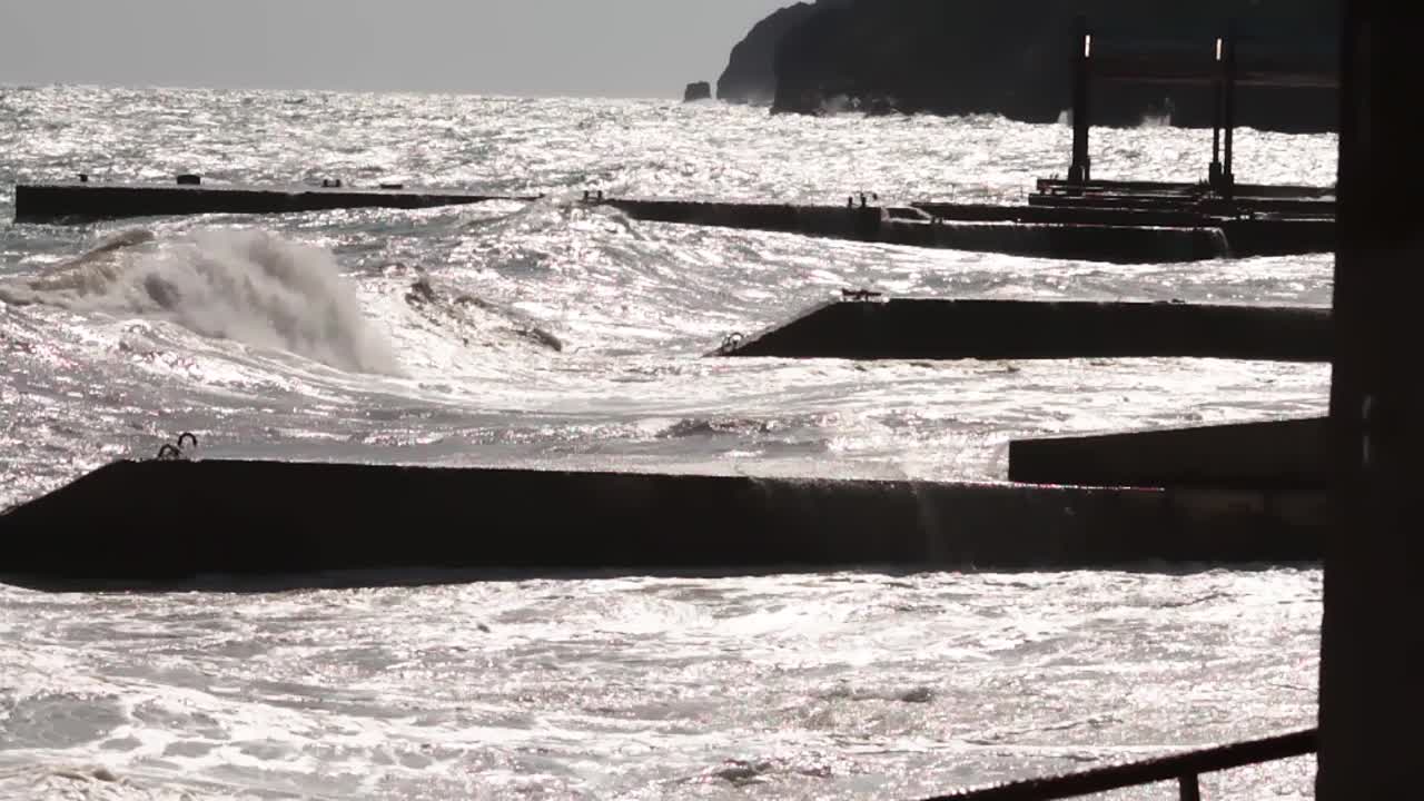 Stormy Ocean Waves Crashing Against Breakwaters