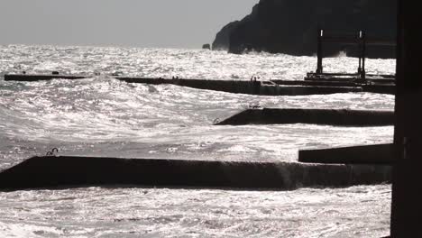 stormy ocean waves crashing against breakwaters