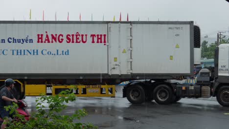 bus drive out from da nang terminal, box truck passing through, after rain, slow-motion