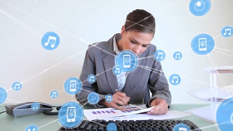 Animation-of-connected-icons-over-caucasian-woman-analyzing-report-and-using-computer-in-office