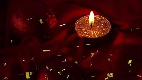 animación de confeti de oro que cae sobre una vela de luz de té encendida en un fondo oscuro