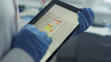 doctor hands using tablet checking health history data in tablet in office.