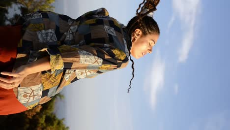 stylish woman dancing in countryside