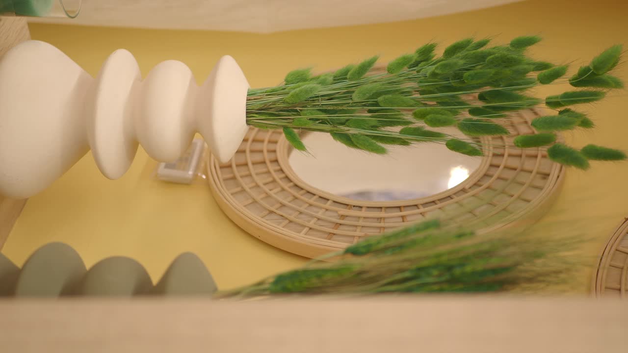 Decorative vase with greenery and mirror