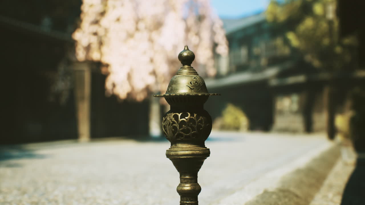Sculpted ornament stands guard in a tranquil street under blossoming trees