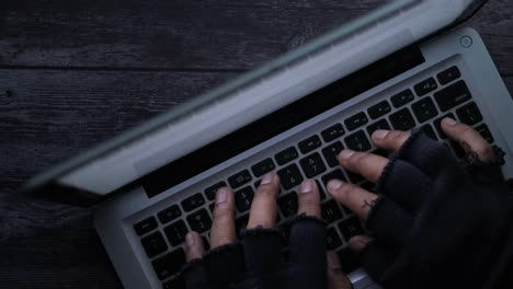 hands typing on a laptop - potential hacking activity