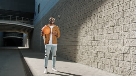 man with basketball in urban setting