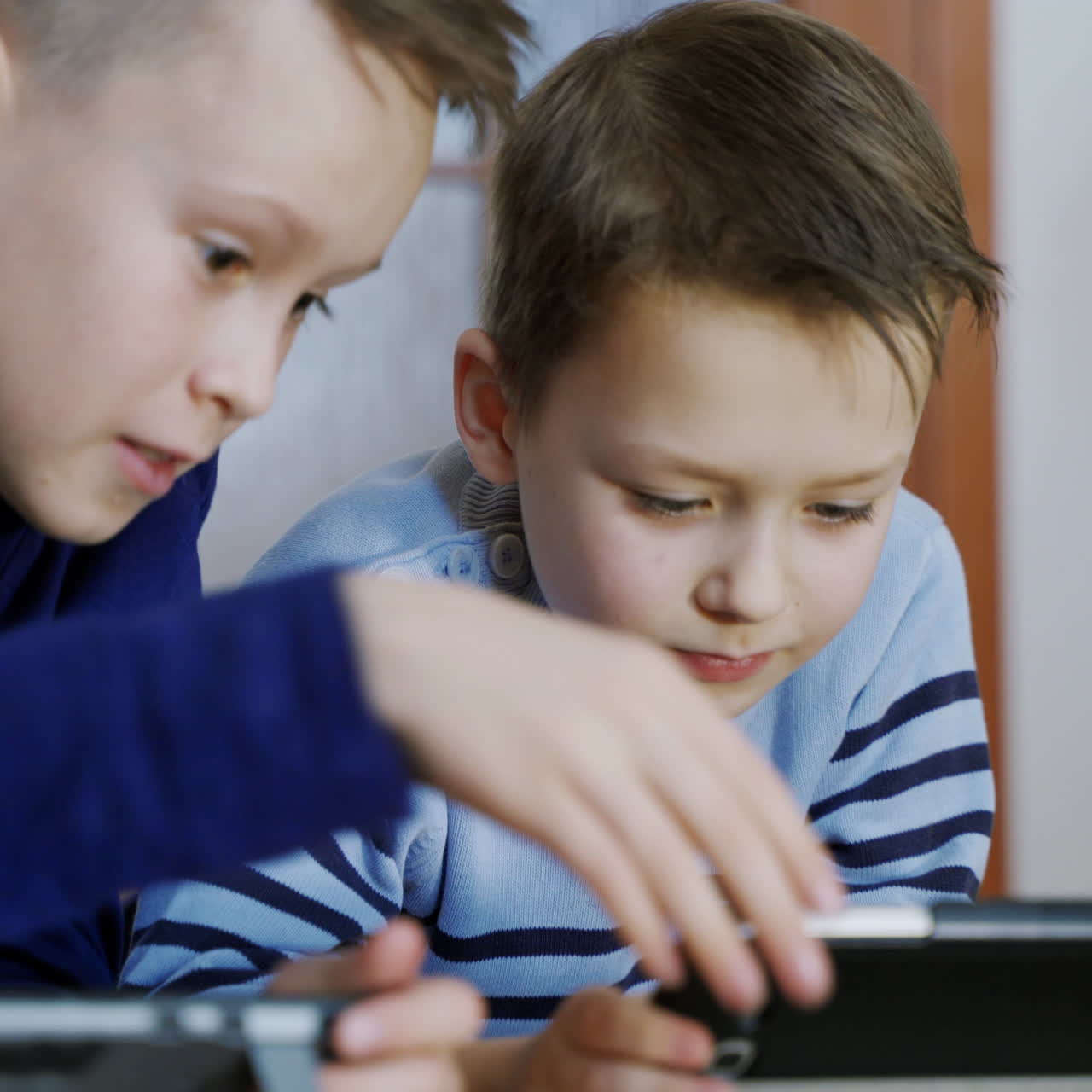 Preschool boys playing on smartphone. Peaceful pastime. Technology and lifestyle concept