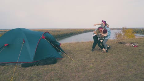 girl tourists have funny party at campsite on green hill