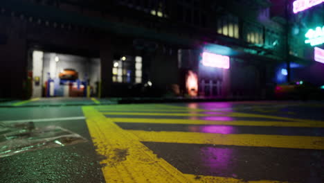 neon lights illuminate a wet street at night in an urban setting