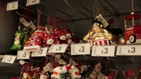 various festive retail glittering christmas decorations hanging for sale in store interior display