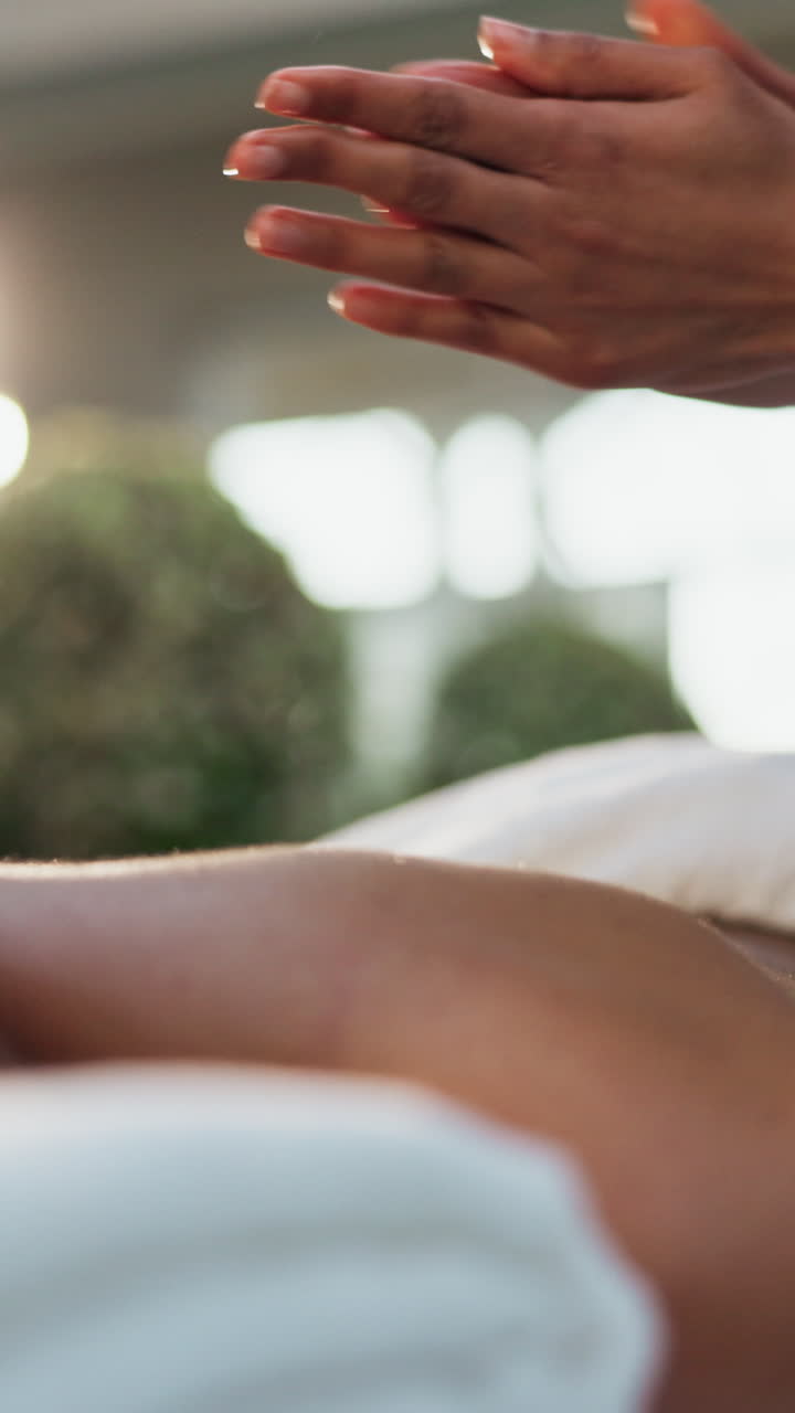 Nærbillede af hænder, der påfører massageolie på ben