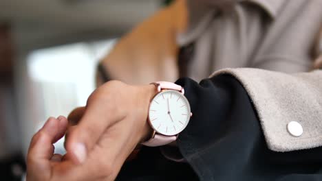 a close-up of a person wearing a pink wrist watch