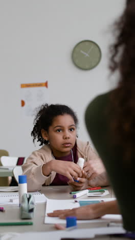 girl doing craft project in classroom