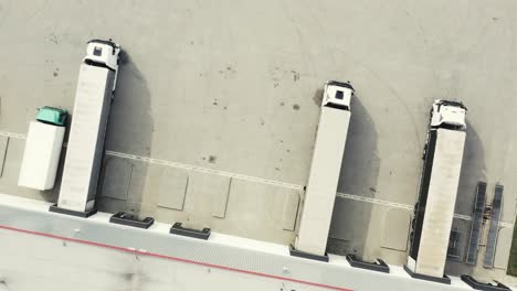 aerial view of the logistics warehouse with trucks waiting for loading