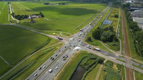 drone clip showing a major highway crossing with cars, bike paths, and surrounding green fields