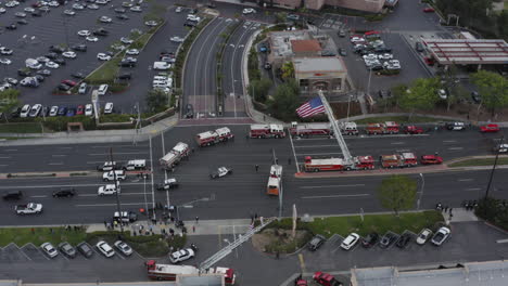 police-cars-drive-through-a-procession-to-honor-a-officer-killed-in-a-helicopter-crash