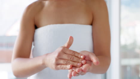 Skincare,-product-and-hands-of-woman-in-a-bathroom