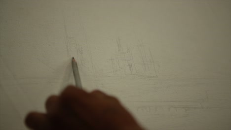 Painter`s hands drawing a sketch with pencil