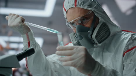 science expert protective suit filling test tube with chemical substance closeup