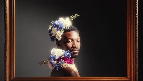 portrait of african american man adorned with flowers inside frame