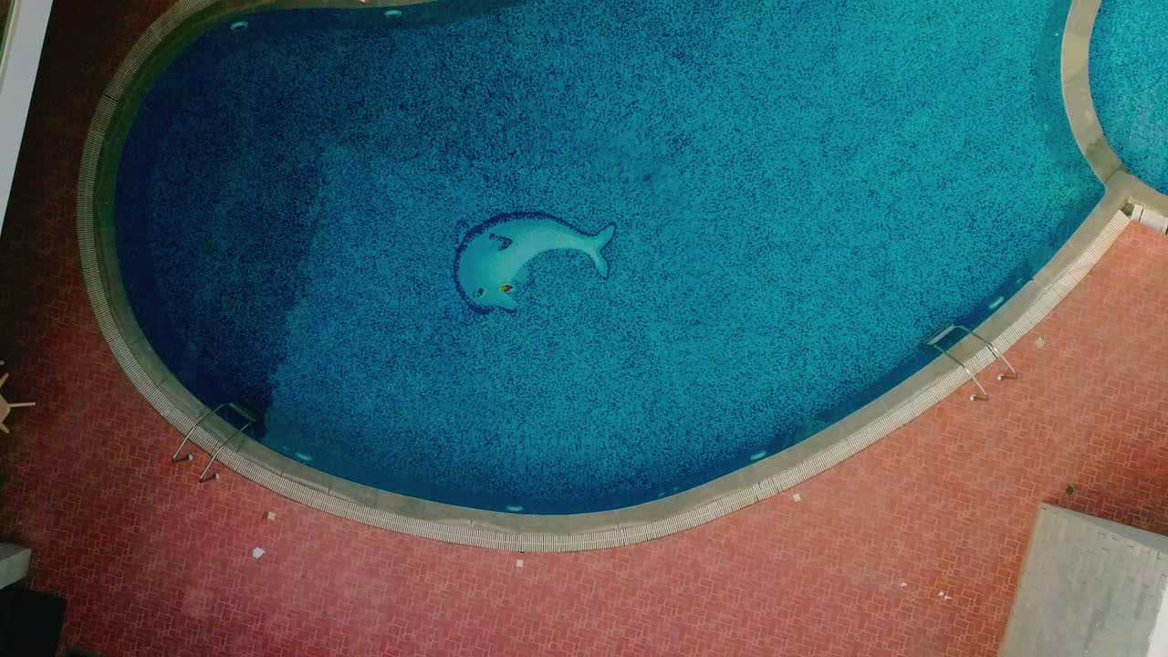 A clear blue resort swimming pool in Davanagere, Karnataka India, peaceful atmosphere, aerial view