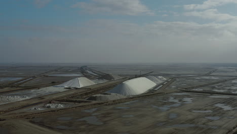 aerial drone flight around salt dunes in the biggest saline of the mediterranean