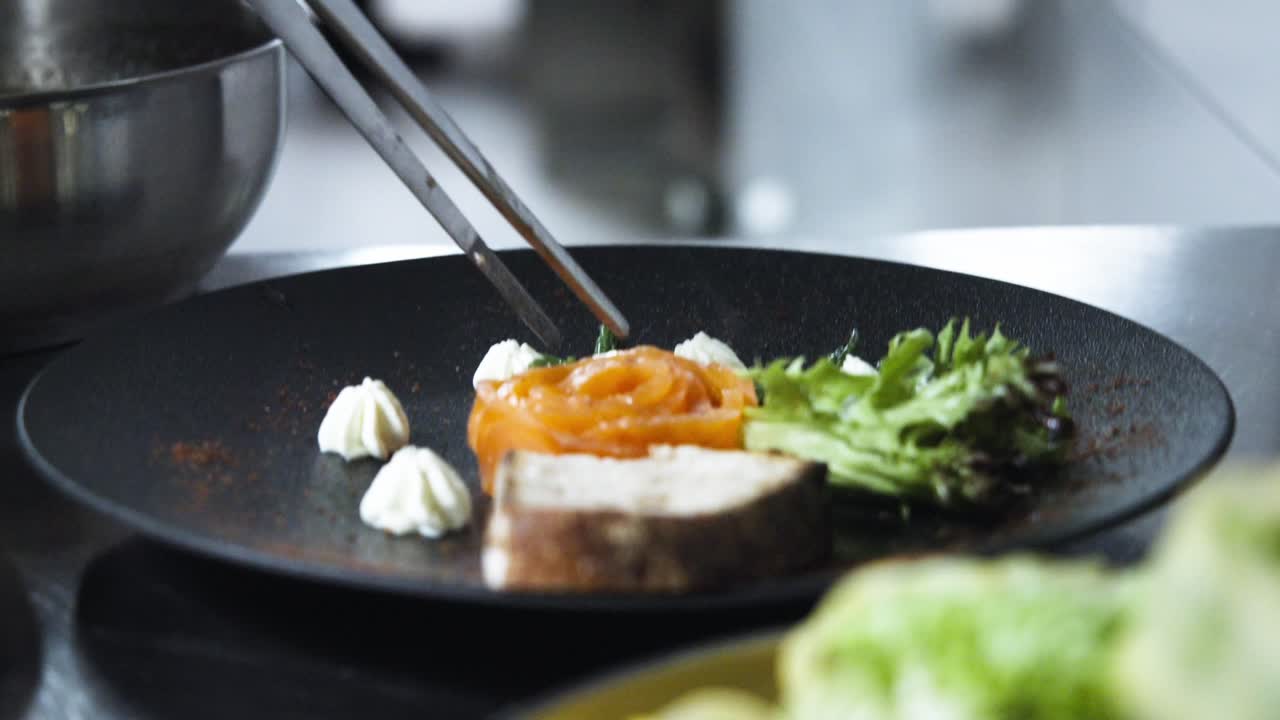 Chef's Added Finishing Touches by Garnishing Dish in High-End Kitchen Close-Up