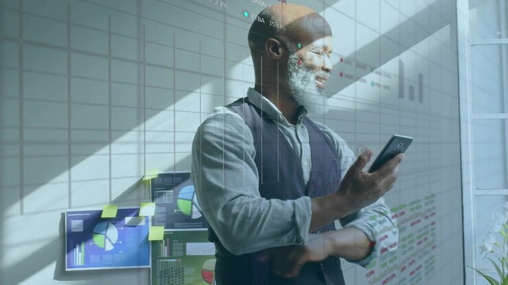 A businessman is using a mobile phone in an office
