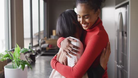 video of happy biracial female friends embracing