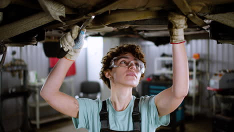 woman repairing car