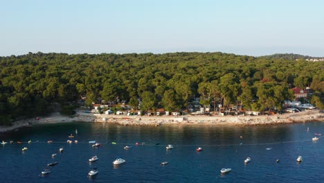 aerial shot over a bay full of anchored boats in mali losinj, croatia on a bright day