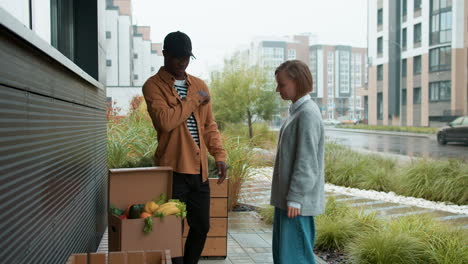 courier delivering box of vegetables