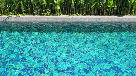 crystal clear swimming exotic pool water, with the light reflecting off the surface