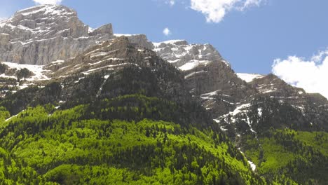 Panoramic-snow-capped-mountain-range-with-clouds-building,-time-lapse