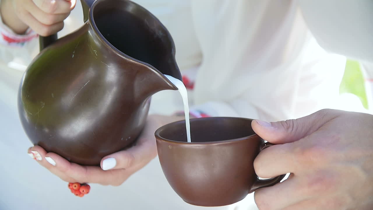 Pouring milk into a cup