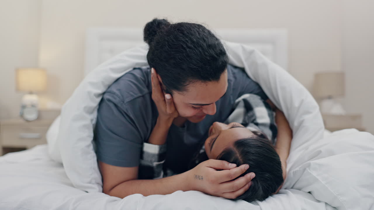 Happy, kiss and a couple in bed for love