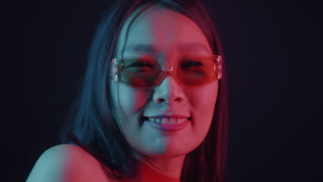 stylish woman posing in neon lighting