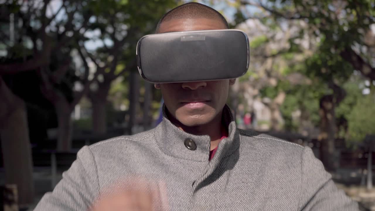 Young man wearing virtual reality headset outdoor