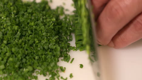 hands chopping fresh chives in slow motion - sushi ingredients - close up