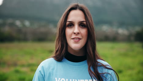 portrait of a smiling woman volunteering outdoors