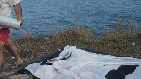 man collecting tent