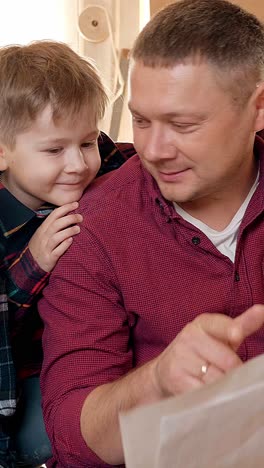 father and son engaged in reading together, showcasing a moment of connection and learning in a cozy indoor environment with warm lighting