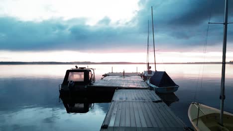 Cinematic-view-of-speedboat-of-lake-during-sunset-on-background-of-beautiful-reflection-of-sunlight-on-water