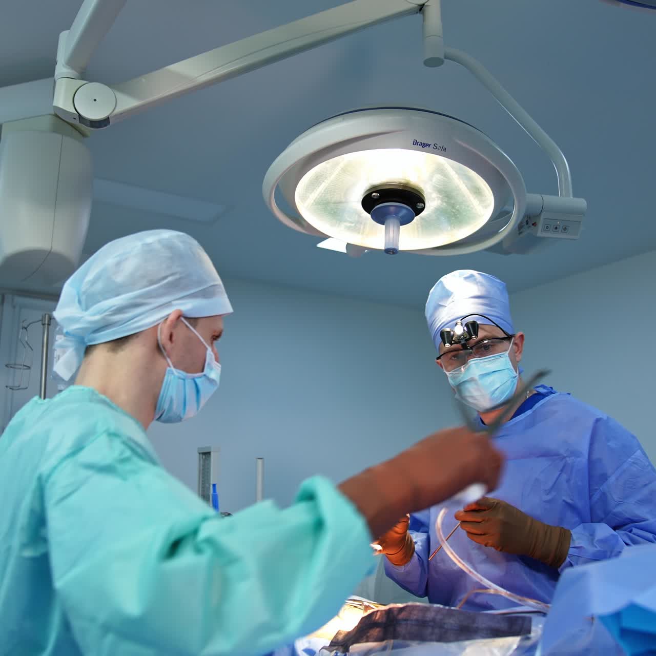 Neurosurgeon operating with a number of instruments. Doctor and his assistant performing surgery in operational theatre
