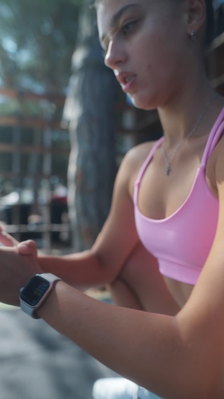 Young Woman Exercising Outdoors in Pink Sports Bra