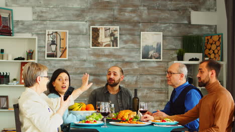 cheerful family laughing while video call chatting