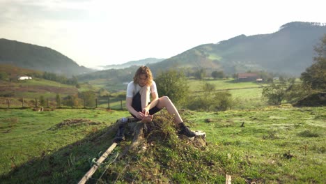 nature hiking backpacking man makes break to inspect painful blisters